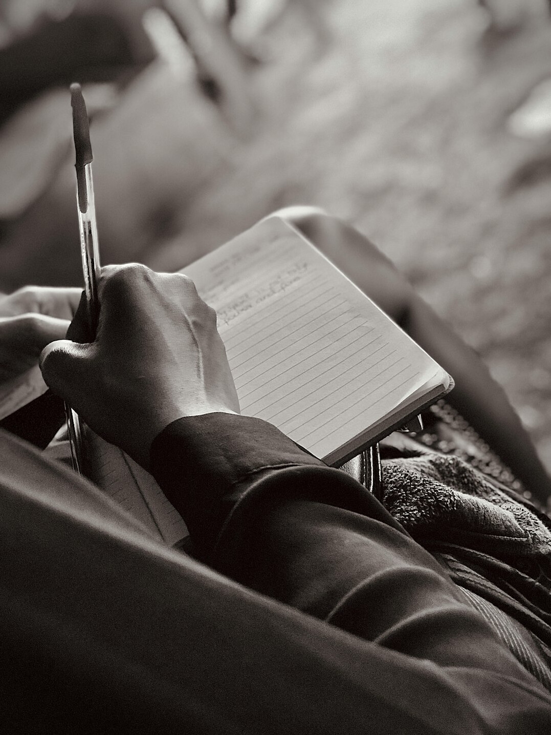 woman writing notes in notebook