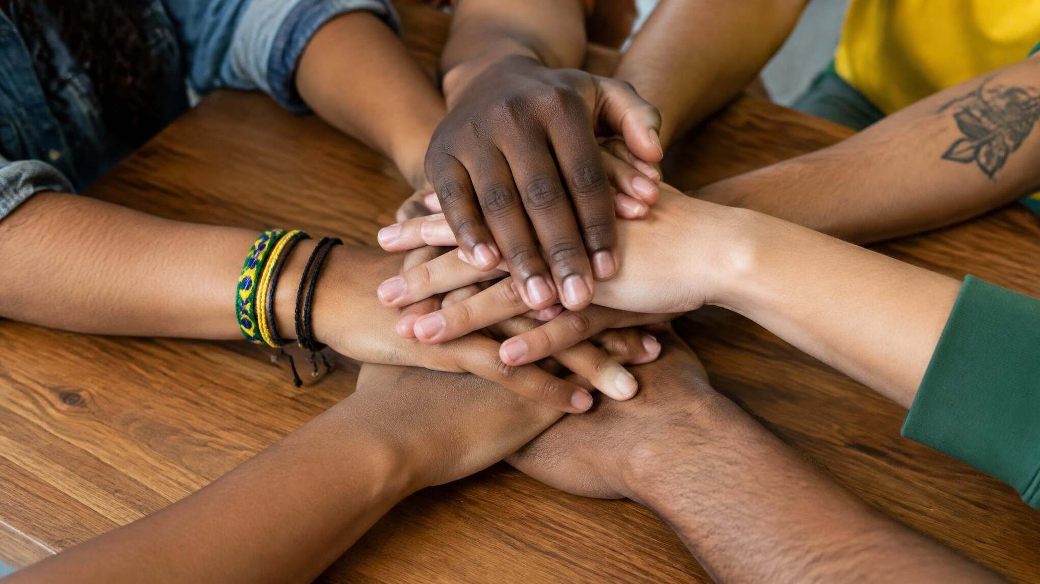 Team putting hands together in unity