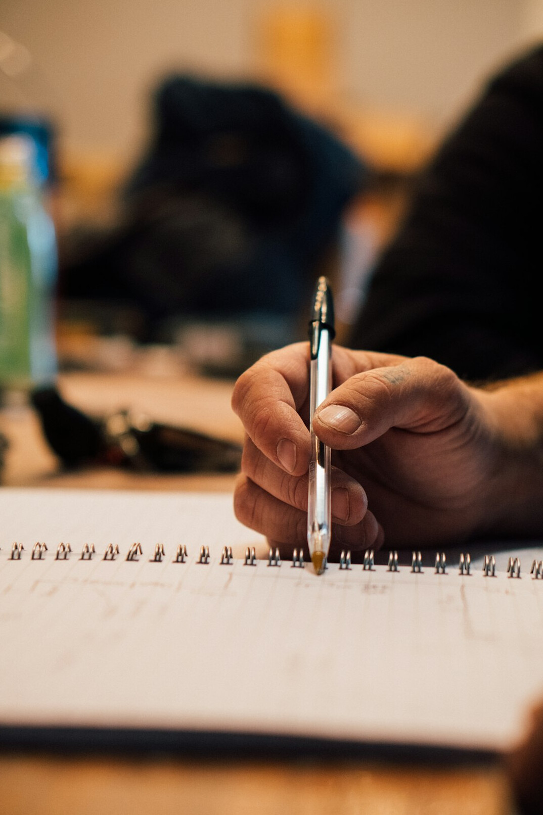 person writing goals in notebook